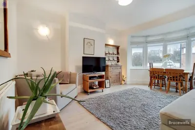 a living room with a couch and a tv and a table at Crouch End in Moffat