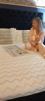 a picture of a doll sitting on a bed at Town Centre Apartment in Gatehouse of Fleet