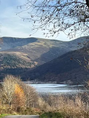 a view of a lake with mountains in the background at West Cumbria static caravan in Workington
