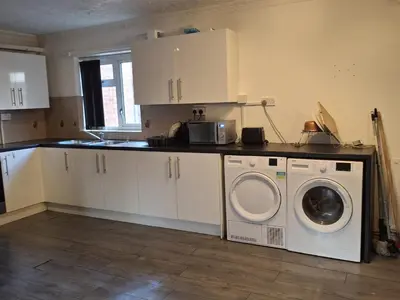 a kitchen with a washer and a washing machine at Akwaaba services in Moffat