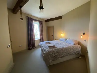 a bedroom with a bed and a window at Highside farm in Embleton