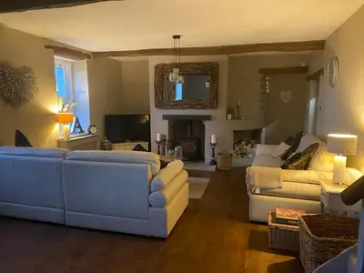 a living room with a white couch and a living room with a fireplace at Highside farm in Embleton