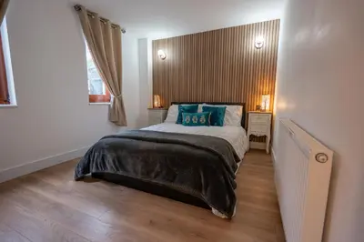 a bedroom with a large bed with blue pillows at Moffat Apartment with Hot Tub in Moffat
