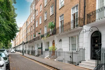 a row of buildings on a city street at Knightsbridge Duplex Two Bedroom Apartment in Moffat