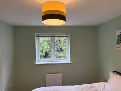 a bedroom with a bed and a window at Pearl House in Moffat