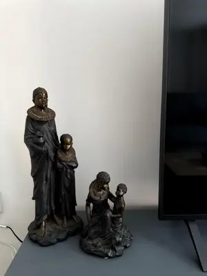 a figurine of a family standing next to a television at Pearl House in Moffat
