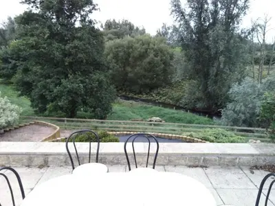 a view of a pool of water with two chairs at Sevenacres Kelso in Moffat