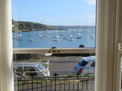 a view of a harbor with boats in the water at THE WHEEL,Harbour view apartment for two - private front entrance and patio in Moffat