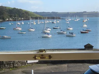 a bunch of boats sitting in the water at THE WHEEL,Harbour view apartment for two - private front entrance and patio in Moffat