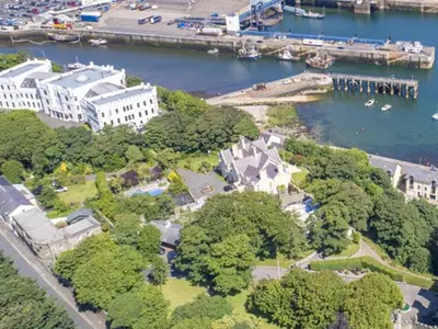 an aerial view of a building next to a body of water at Ravenscliffe Lodge in Douglas
