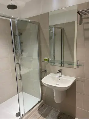 a bathroom with a sink and a shower at The Palms in Moffat