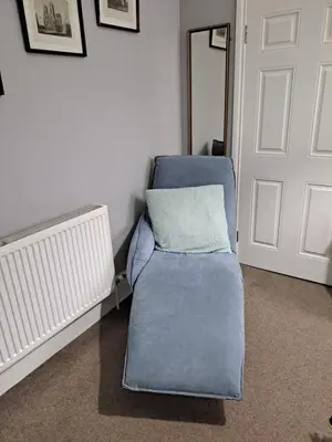 a blue couch with a pillow on it in a room at Brewery house in Newton Stewart