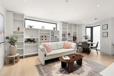 a living room with a white couch and a table at Stylish 2-Bedroom Flat On Seven Sisters Rd in Moffat