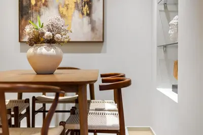 a vase of flowers sitting on a wooden table at Bright 3BR London Flat w Full Kitchen in Moffat