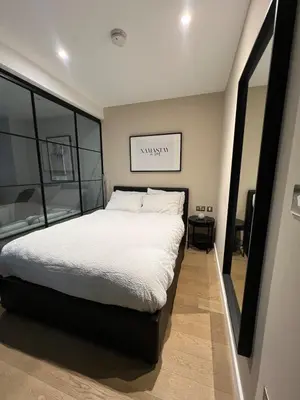 a bedroom with a bed and a large window at Modern City Apartment, Fast Wi-Fi, Great View in Moffat