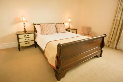 a bedroom with a large bed with two night stands at Springkell in Eaglesfield