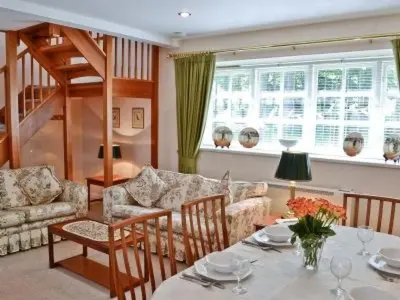a living room with a table and a couch at Holiday Home Gehöft 4 by Interhome in Tweedsmuir