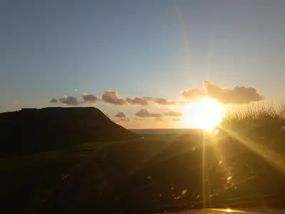 a sunset over a field with the sun in the sky at 'Sunset Lodge' Peaceful Coastal Retreat with Hot Tub in Monreith