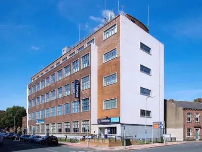 a large brick building on the corner of a street at Travelodge Carlisle Central in Carlisle