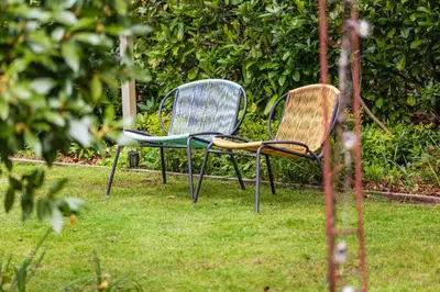 two chairs sitting in the grass in a yard at Woodside B & B in Keswick