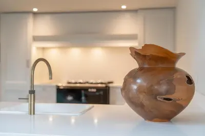 a brown vase sitting on a counter in a kitchen at Luxurious Barn within easy reach of South Lakes! in Boot