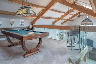 a pool table in a room with a ceiling at Luxurious Barn within easy reach of South Lakes! in Boot