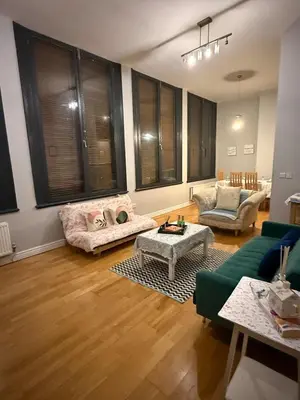 a living room with a couch and a table at Flat in the heart of Liverpool city centre in Moffat