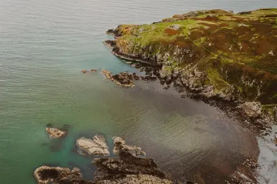 an aerial view of the ocean and a rocky coast at Castle Penthouse on Estate by the Sea in Enoch