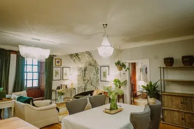 a living room with a table and chairs at Castle Penthouse on Estate by the Sea in Enoch