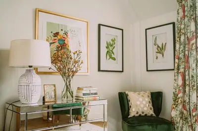 a living room with a green chair and a glass table at Castle Penthouse on Estate by the Sea in Enoch