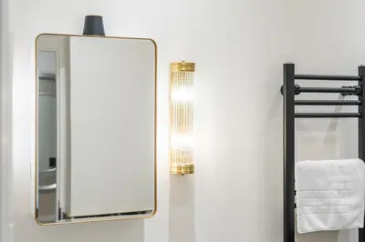 a bathroom with a mirror and a towel rack at Central Jewellery Quarter 1-Bedroom with Parking in Moffat