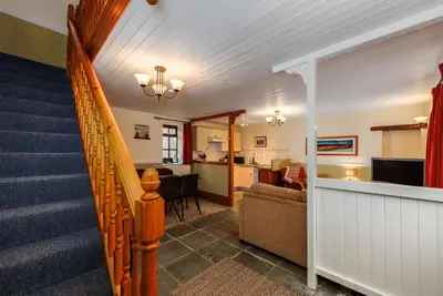 a staircase in a home with a living room at Stables Cottage - Wythop Mill in Embleton