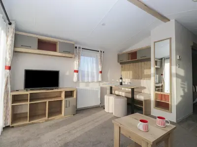 a living room with a television and a table at Guillemot in St Bees