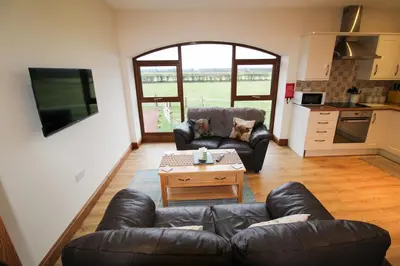 a living room with a couch and a coffee table at Centurion, Irthington on Hadrians Wall in Irthington