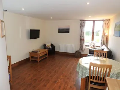 a living room with a table and a couch at Fortress, Irthington on Hadrians Wall in Irthington