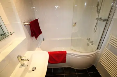 a white bathroom with a tub and a sink at Milecastle, Irthington on Hadrians Wall in Irthington