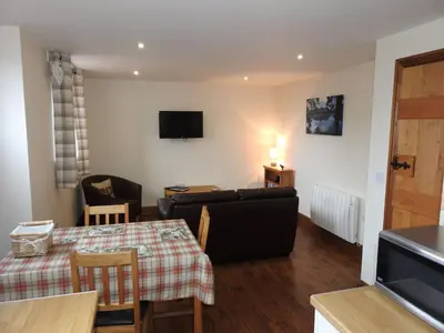 a living room with a couch and a table at Stanegate, Irthington on Hadrians Wall in Irthington