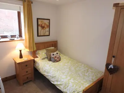 a small bedroom with a bed and a window at Stanegate, Irthington on Hadrians Wall in Irthington