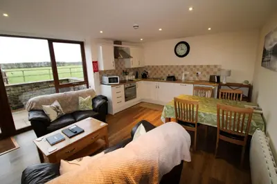a kitchen and living room with a table and a couch at Vallum, Irthington on Hadrians Wall in Irthington