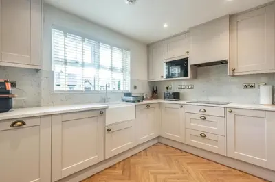 a white kitchen with white cabinets and a window at 2 Bed in Gretna Green oc-n34146 in Gretna Green