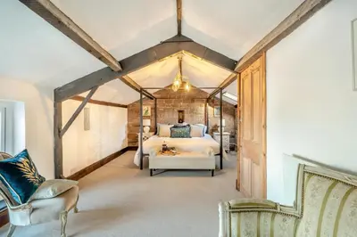 a bedroom with a bed and a chair in a room at 6 Bed in Low Moresby oc-l34667 in Distington