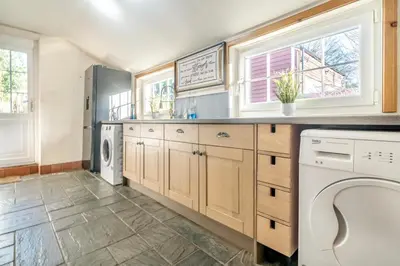 a large kitchen with a washer and dryer at 6 Bed in Low Moresby oc-l34667 in Distington