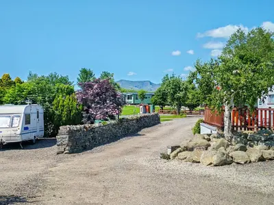 a rv parked next to a stone wall at Blencathra View - Uk50085 in Penruddock