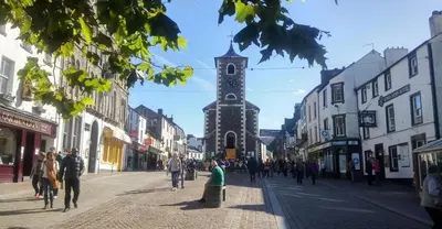 a street with a clock tower in the middle of a city at Wordsworth Cottage in Keswick
