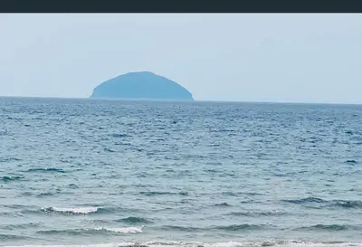 a large body of water with an island in the distance at Ailsa Seaview in Turnberry