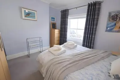 a bedroom with a bed with two towels on it at Riverside Heights- Dog Friendly Lakeland Retreat in Town Centre in Cockermouth