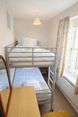 two bunk beds in a room with a window at Riverside Heights- Dog Friendly Lakeland Retreat in Town Centre in Cockermouth