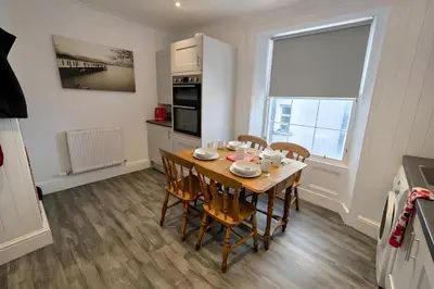 a kitchen and dining room with a table and chairs at Riverside Heights- Dog Friendly Lakeland Retreat in Town Centre in Cockermouth