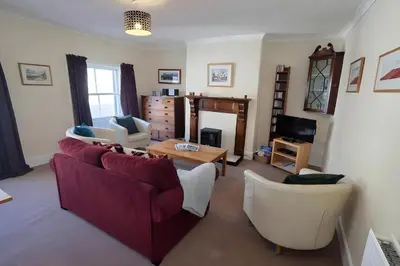 a living room with a couch and a table at Riverside Heights- Dog Friendly Lakeland Retreat in Town Centre in Cockermouth