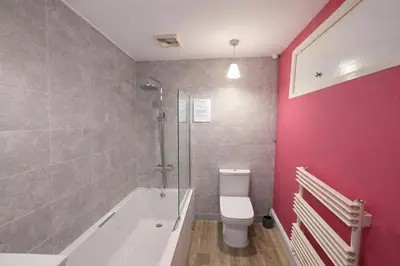a bathroom with a tub and a toilet and a shower at Riverside Heights- Dog Friendly Lakeland Retreat in Town Centre in Cockermouth